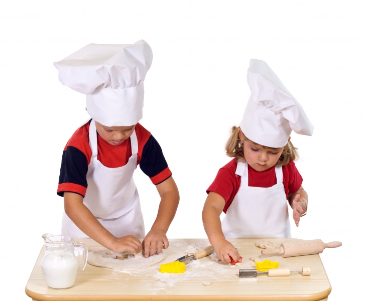 children-making-cookies-dressed-as-chefs